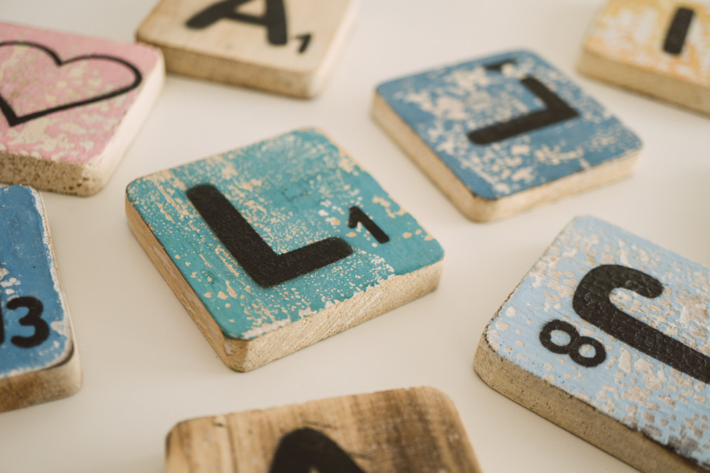 Colourful Scrabble tiles on white table