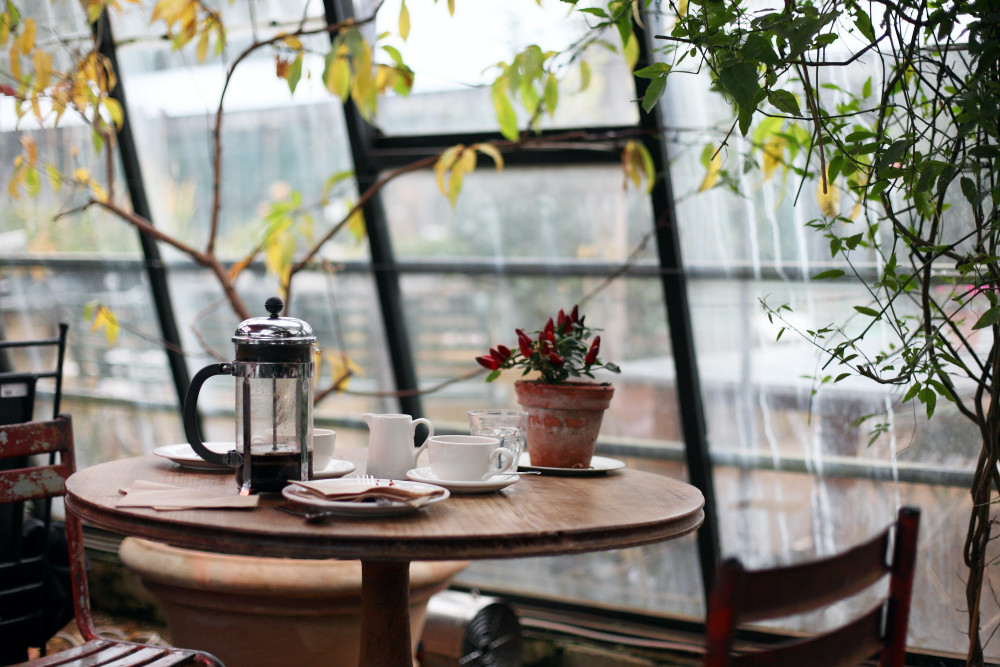 Cafe table for two with coffee, crockery and cutlery